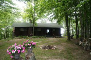 Exterior of Cabin 2 with flower baskets