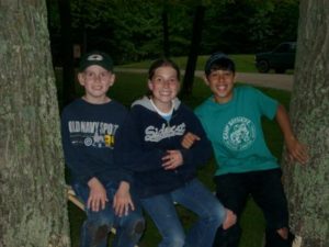 Three friends celebrating a sixth-grade graduation in 2004