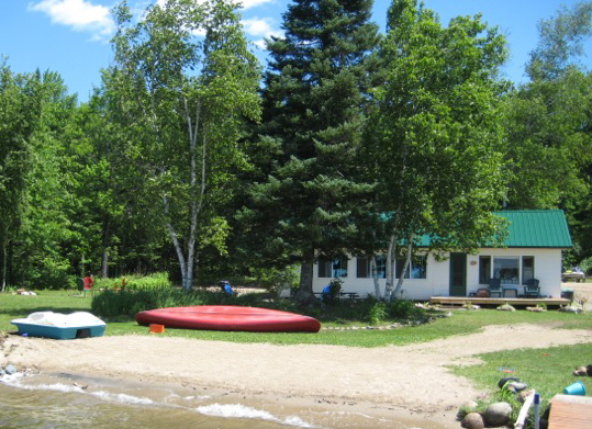 Shallow sandy swimming beach beside Wabana Lake