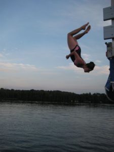 Wakeboarder performing a jump near the dock