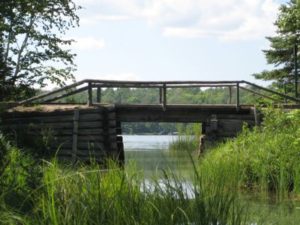Wooden footbridge across a resort inlet