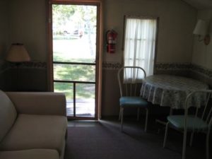 Cabin guest room with sofa, bed, and lake view