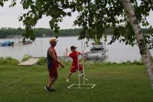 Two children walking near the lakeshore