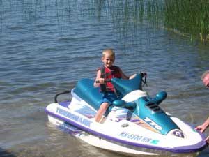 Matthew riding a jet ski on Wabana Lake