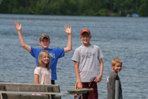 Three boys standing on the dock