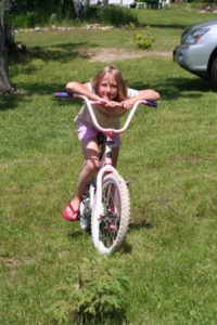 Child riding a bicycle on the resort lawn