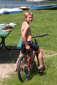 Ben riding a bicycle near the beach