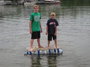 Two children standing on a floating raft