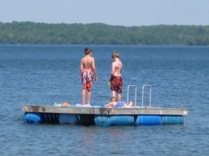 Two children on a floating swim platform