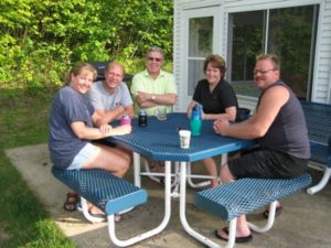 Family and friends gathered at a picnic table