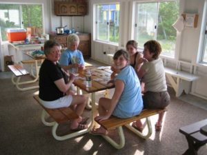 Guests sharing a meal in the screened porch