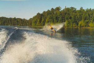 Water skier creating spray on a calm lake