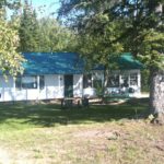 Exterior of Cabin 4 among mature trees