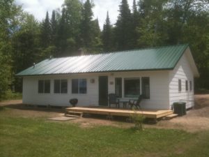 Exterior of Cabin 6 with a picnic table