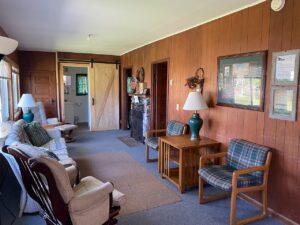 Cabin 6 sitting room with wood-paneled walls