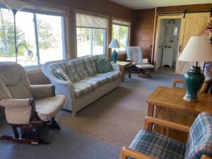 Cabin 6 living room with a sofa and rocking chairs