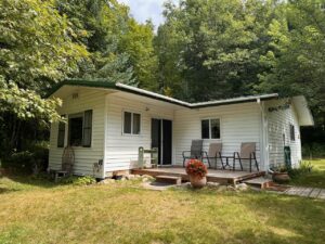 Exterior of Cabin 3 with a small patio