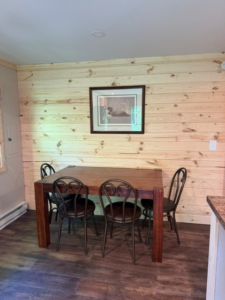 Cabin 1 dining area with a wood table and chairs