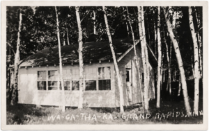 Historic WA-GA-THA-KA cabin among birch trees in Grand Rapids, Minnesota